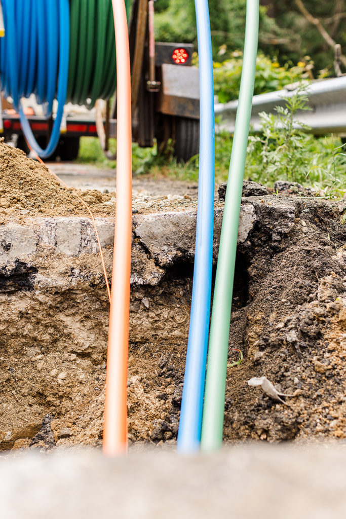 Several colored cables enter the ground