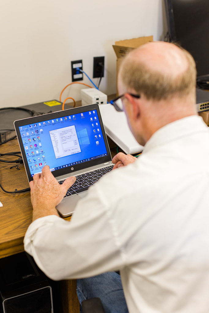 A man works on a laptop