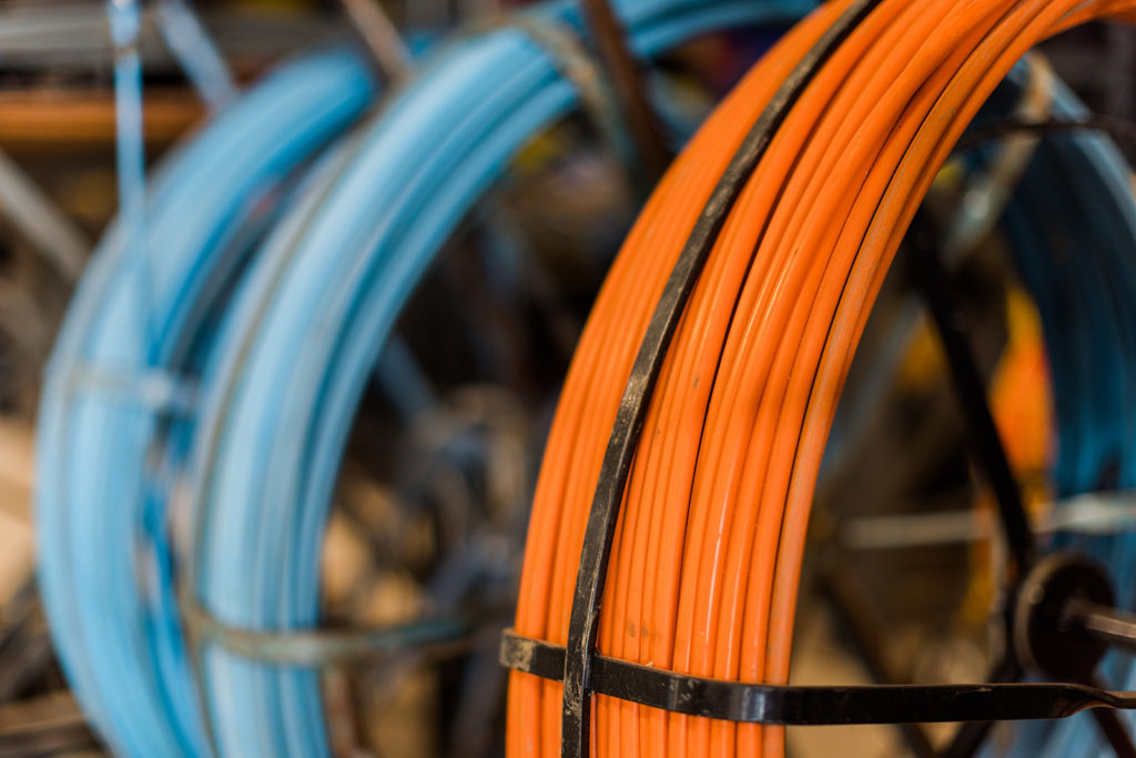 Spools of blue and orange cable, held together with plastic ties