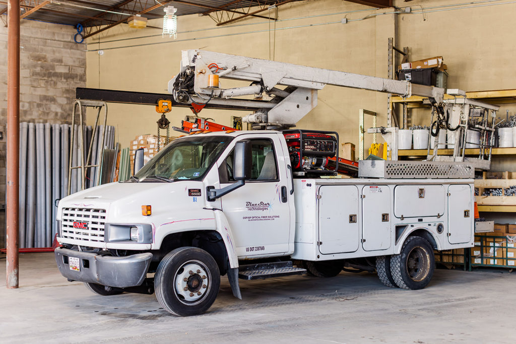 A white company truck parked in a garage