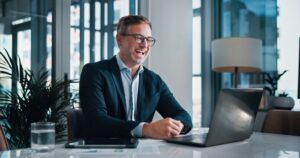 Business, man and laughing on laptop video call